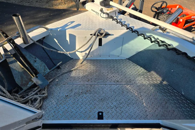 Slide: The Image of 2021 Alumaweld Intruder Outboard 20 boat deck with anchor and ropes. - 14