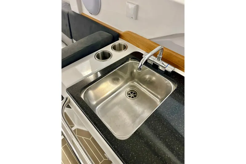 Slide: The Image of Modern kitchen sink in 2023 Nimbus Weekender 9 boat, featuring stainless steel and sleek design. - 19