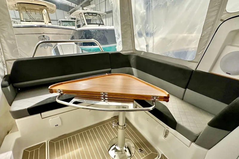 Slide: The Image of Interior of 2023 Nimbus Weekender 9 boat with sleek seating and wooden table. - 25