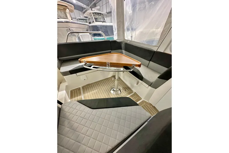 Slide: The Image of Interior of 2023 Nimbus Weekender 9 boat with seating and wooden table. - 29