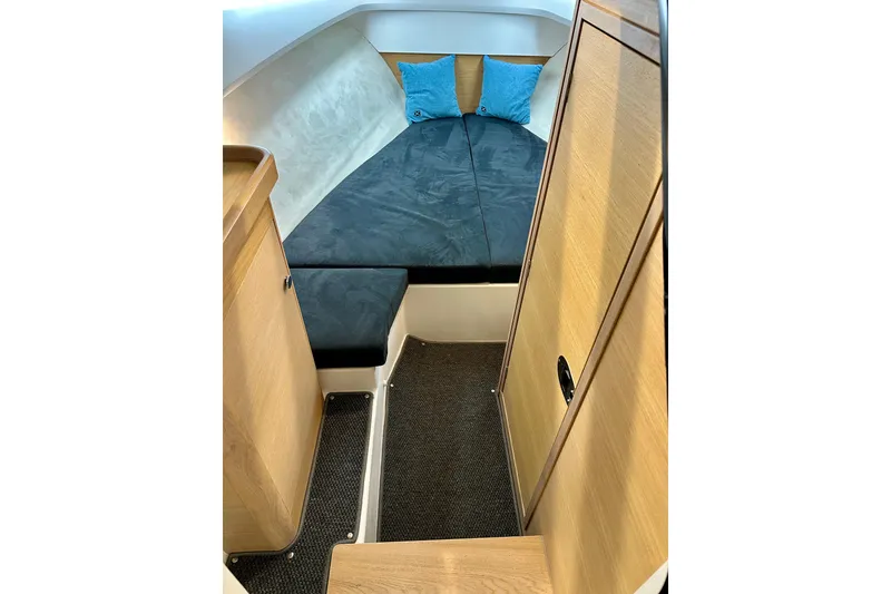 Slide: The Image of 2023 Nimbus Weekender 9 cabin interior with cozy bed and wooden cabinetry. - 30