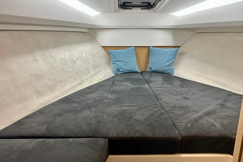 Slide: The Image of 2023 Nimbus Weekender 9 cabin interior with cozy bedding and blue pillows. - 32