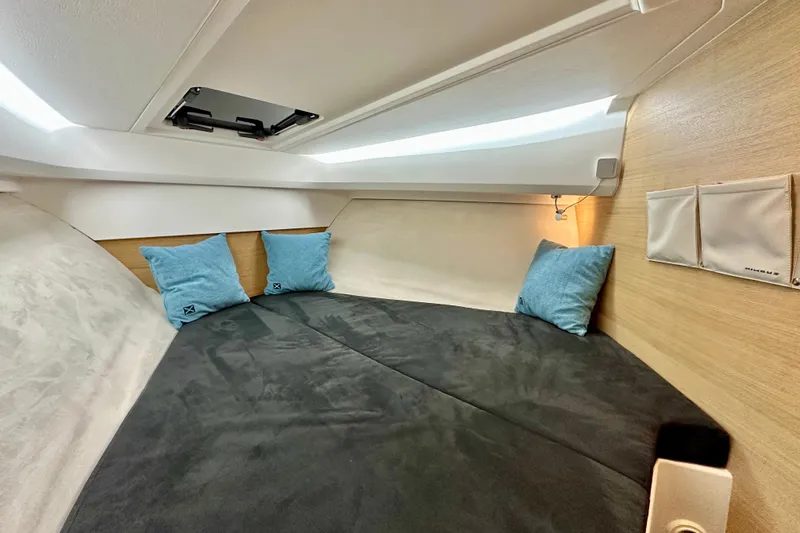 Slide: The Image of Cozy cabin interior of 2023 Nimbus Weekender 9 with blue pillows and soft lighting. - 33