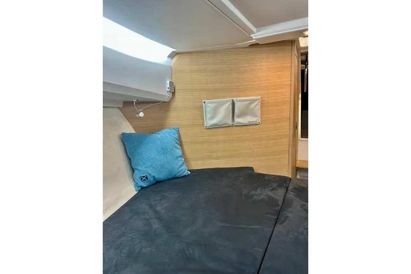 Slide: The Image of 2023 Nimbus Weekender 9 interior cabin with blue pillow and wooden wall paneling. - 34