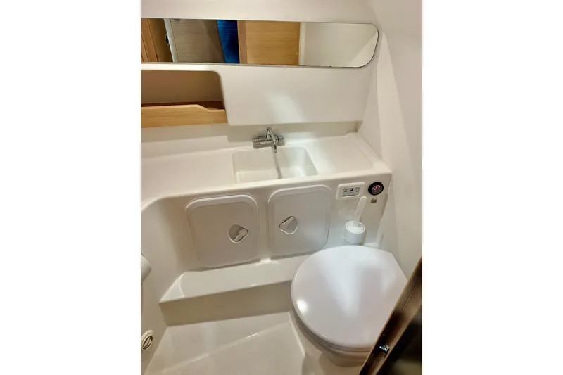 Slide: The Image of 2023 Nimbus Weekender 9 boat bathroom with sink, mirror, and toilet. - 38