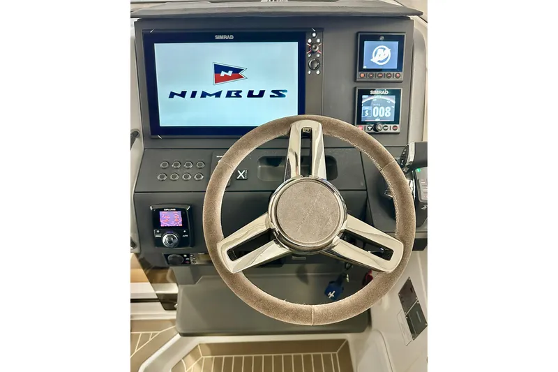 Slide: The Image of 2023 Nimbus Weekender 9 helm with modern steering wheel and digital displays. - 9