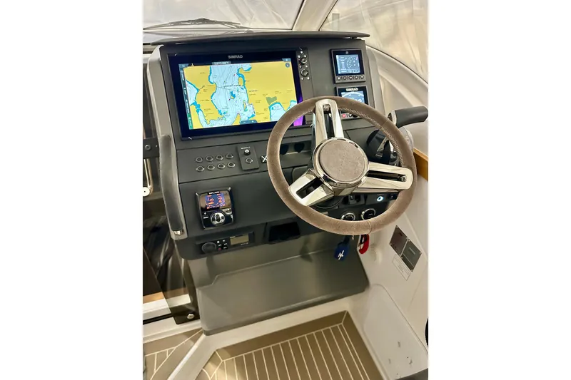 Slide: The Image of 2023 Nimbus Weekender 9 dashboard with navigation display and steering wheel. - 10