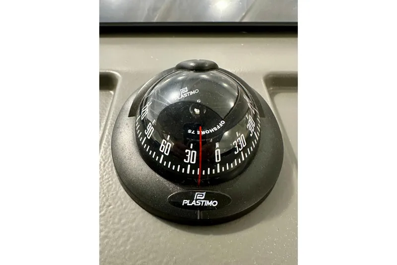 Slide: The Image of Compass on 2023 Nimbus Weekender 9 boat dashboard, featuring Plastimo branding. - 16