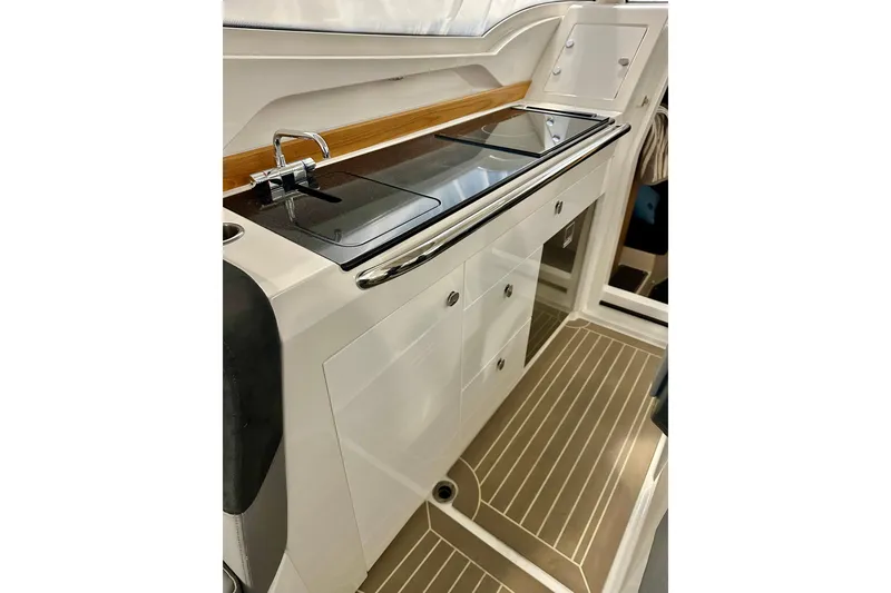 Slide: The Image of 2023 Nimbus Weekender 9 boat interior with sleek kitchenette and modern design. - 17