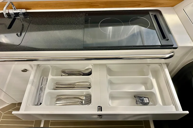 Slide: The Image of Modern kitchen in 2023 Nimbus Weekender 9 with stove and organized cutlery drawer. - 21