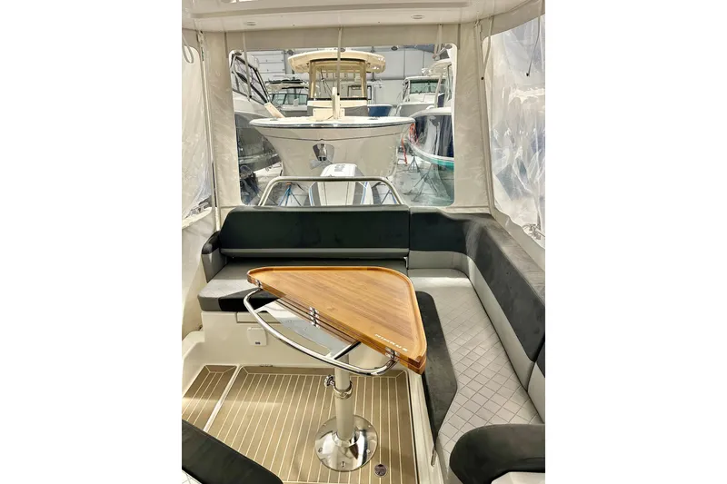 Slide: The Image of Interior of 2023 Nimbus Weekender 9 boat with sleek seating and wooden table. - 26