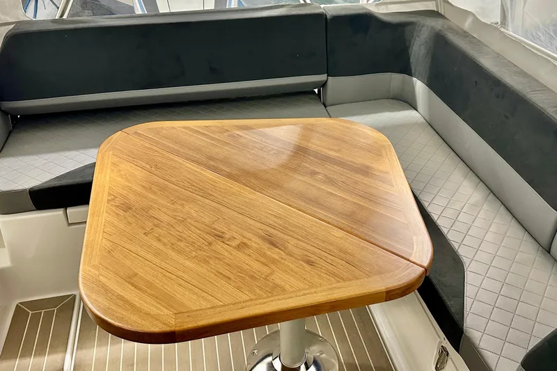 Slide: The Image of 2023 Nimbus Weekender 9 interior with wooden table and cushioned seating. - 28