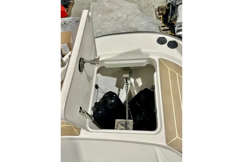 Slide: The Image of Open storage compartment on 2023 Nimbus Weekender 9 boat, showing anchor and chain. - 40