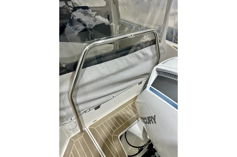 Slide: The Image of 2023 Nimbus Weekender 9 boat interior with Mercury engine and stainless steel railing. - 47