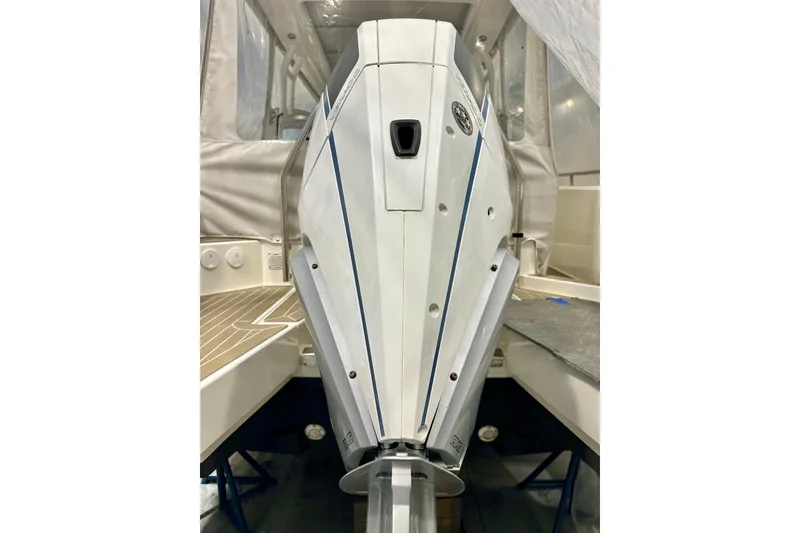 Slide: The Image of 2023 Nimbus Weekender 9 boat engine, sleek design, white and blue accents. - 50