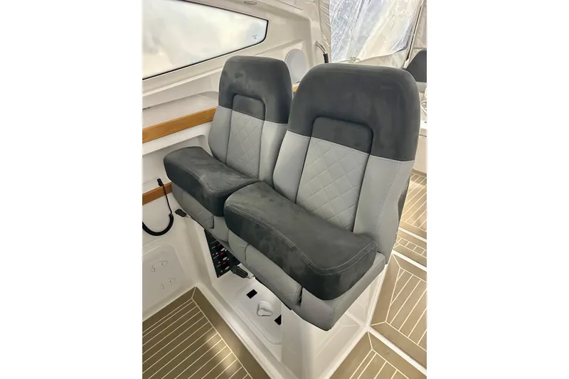 Slide: The Image of 2023 Nimbus Weekender 9 interior with dual gray and black cushioned seats. - 7