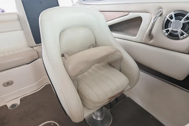 Slide: The Image of White leather boat seat in a 2007 Bryant 270, featuring a built-in speaker. - 10