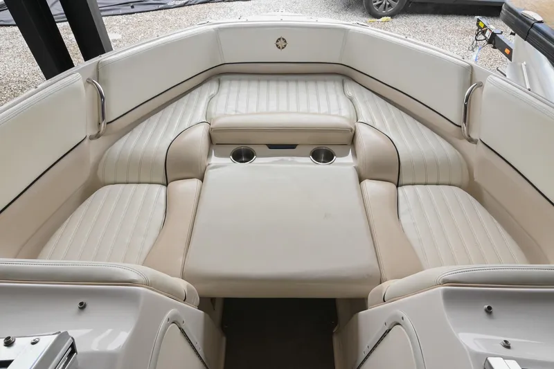 Slide: The Image of Interior of a 2007 Bryant 270 boat with white cushioned seating. - 11