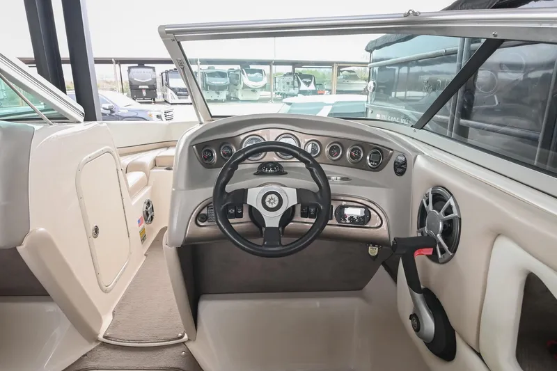 Slide: The Image of Interior view of a 2007 Bryant 270 boat dashboard with steering wheel and gauges. - 15