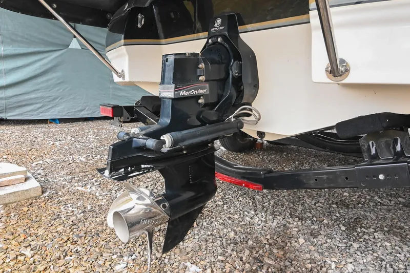 Slide: The Image of 2007 Bryant 270 boat with MerCruiser outdrive on gravel surface. - 18