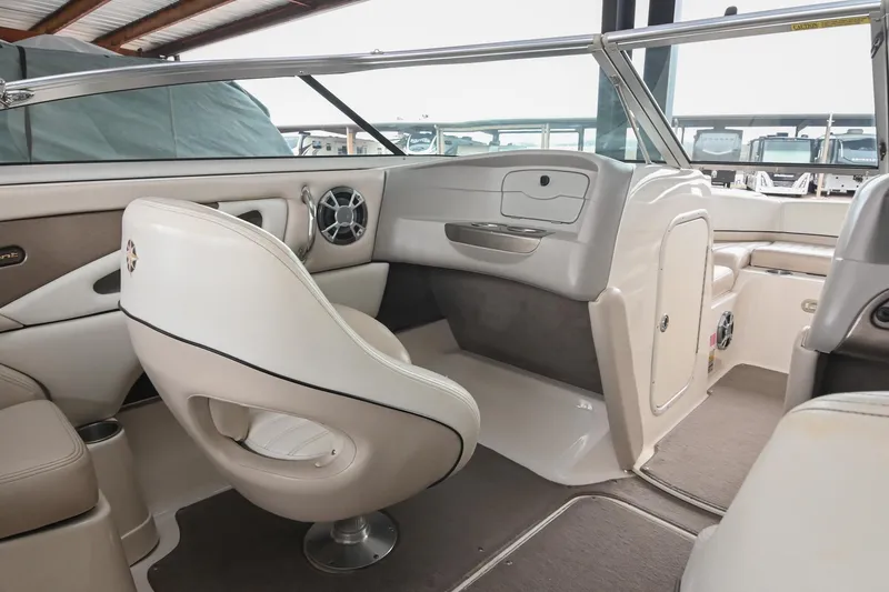 Slide: The Image of 2007 Bryant 270 boat interior with beige seating and modern dashboard design. - 2