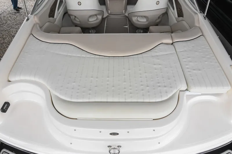 Slide: The Image of 2007 Bryant 270 boat interior with white cushioned seating and sleek design. - 20