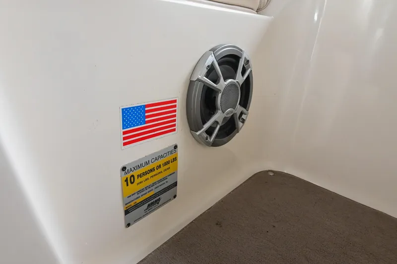 Slide: The Image of 2007 Bryant 270 boat interior with speaker, American flag, and capacity label. - 21