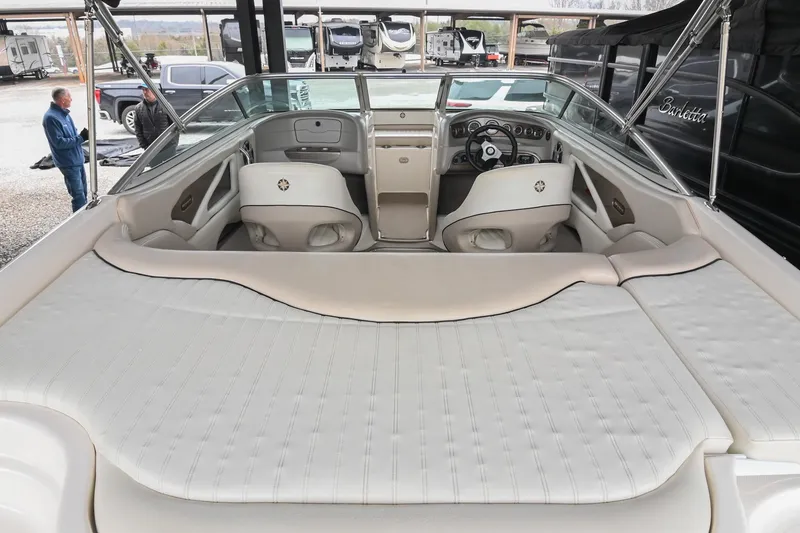 Slide: The Image of 2007 Bryant 270 boat interior with white seating and dashboard view. - 22