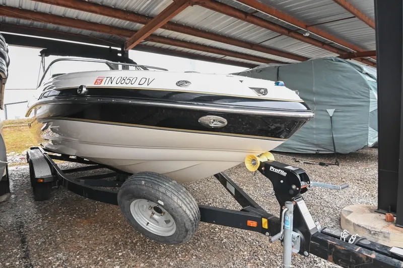 Slide: The Image of 2007 Bryant 270 boat on trailer under metal roof, side view. - 23