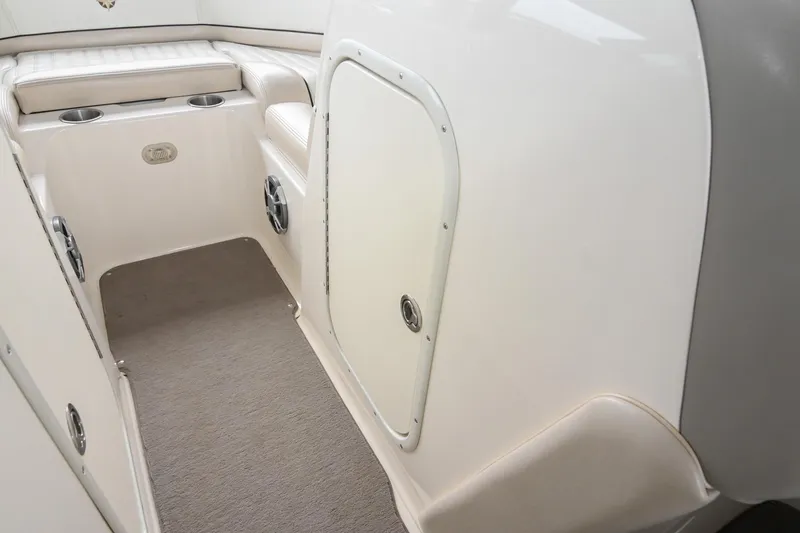 Slide: The Image of Interior of a 2007 Bryant 270 boat, featuring seating and cup holders. - 25