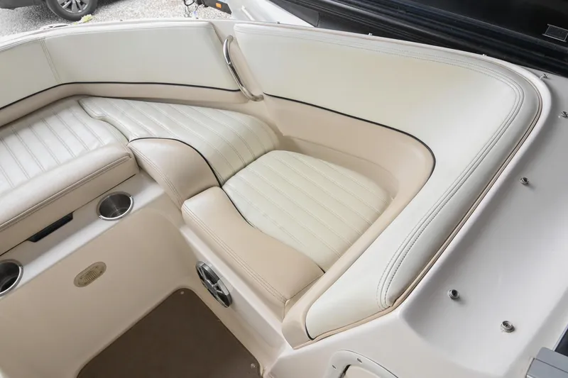 Slide: The Image of Luxurious seating area in a 2007 Bryant 270 boat, featuring white and beige upholstery. - 27