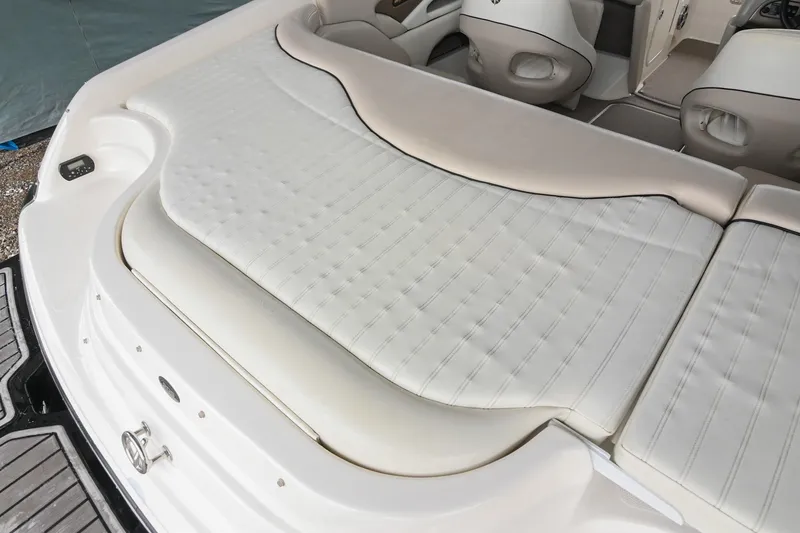 Slide: The Image of 2007 Bryant 270 boat interior with white cushioned seating and sleek design. - 28