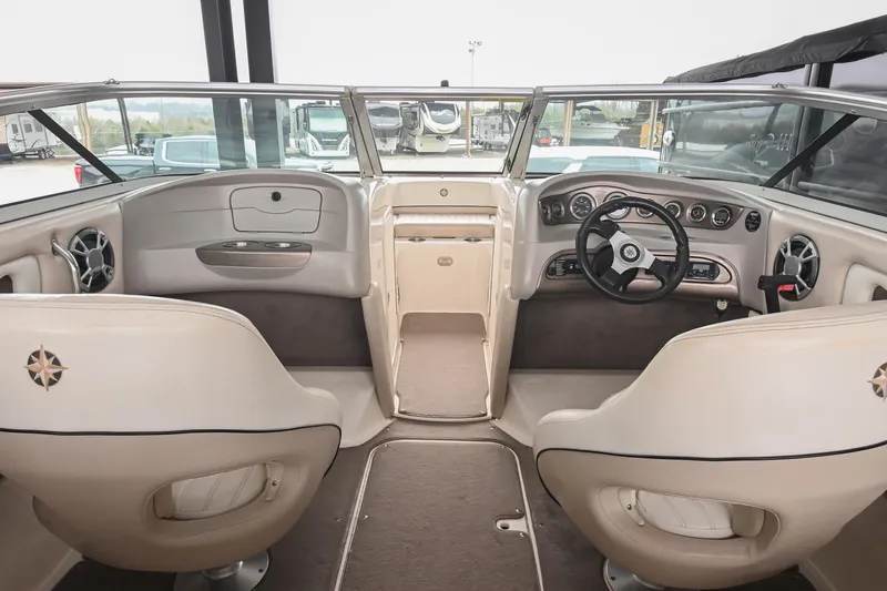 Slide: The Image of Interior of a 2007 Bryant 270 boat, featuring steering wheel and dashboard controls. - 29