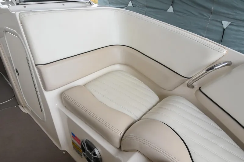 Slide: The Image of 2007 Bryant 270 boat interior with beige and white cushioned seating. - 31