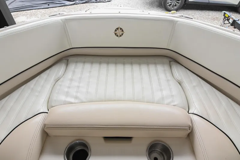 Slide: The Image of 2007 Bryant 270 boat interior with white cushioned seating and cup holders. - 32