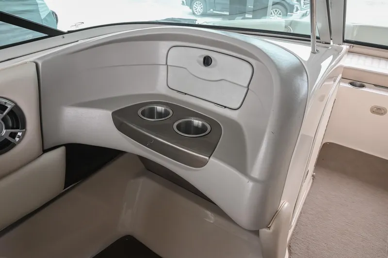 Slide: The Image of Interior of a 2007 Bryant 270 boat featuring cup holders and storage compartment. - 35