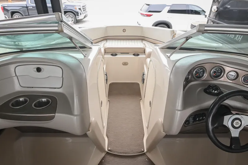 Slide: The Image of 2007 Bryant 270 boat interior with dashboard, steering wheel, and seating area. - 40