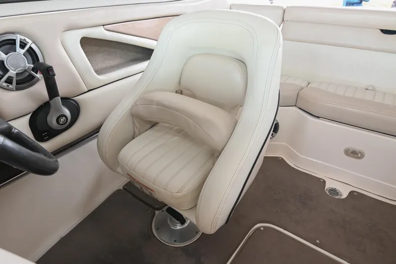 Slide: The Image of 2007 Bryant 270 boat interior with white captain's chair and control panel. - 8