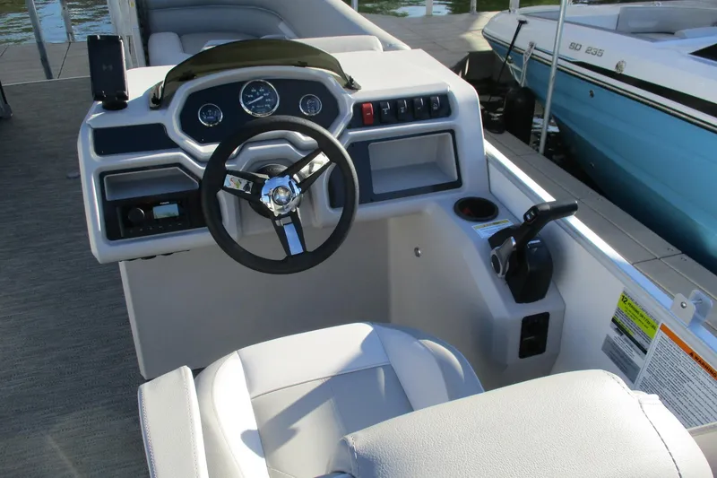 Slide: The Image of 2024 Godfrey Sweetwater 2286 SBX boat helm with steering wheel and controls. - 6