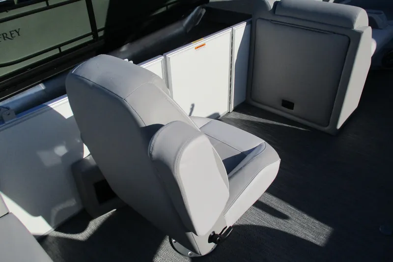 Slide: The Image of 2024 Godfrey Sweetwater 2286 SBX boat interior with gray seating and storage compartments. - 7