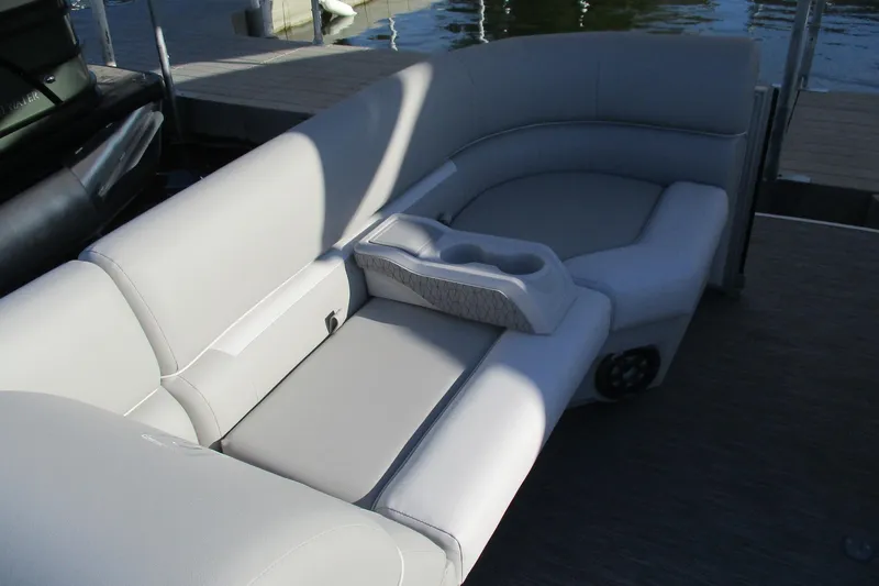 Slide: The Image of 2024 Godfrey Sweetwater 2286 SBX boat interior with plush seating and cup holders. - 9