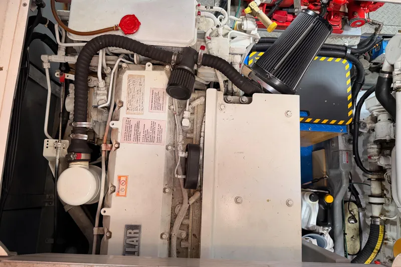 Slide: The Image of Engine compartment of a 1998 Sea Ray 420 Aft Cabin boat, showcasing mechanical components. - 100