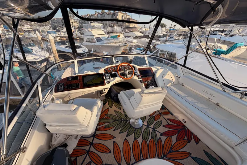 Slide: The Image of Luxurious 1998 Sea Ray 420 Aft Cabin yacht interior with helm and seating at marina. - 28