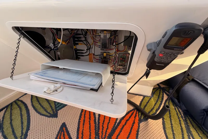 Slide: The Image of 1998 Sea Ray 420 Aft Cabin electrical panel with radio and documents. - 35