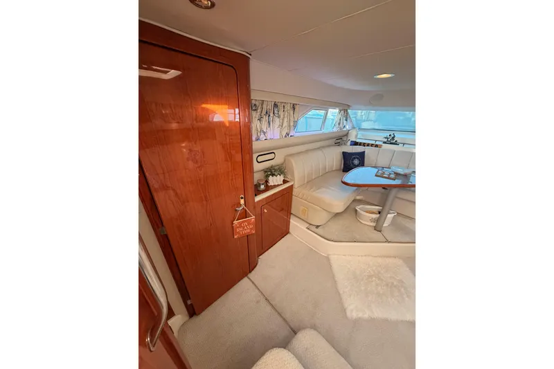 Slide: The Image of Luxurious interior of 1998 Sea Ray 420 Aft Cabin yacht with elegant seating and wooden finishes. - 43