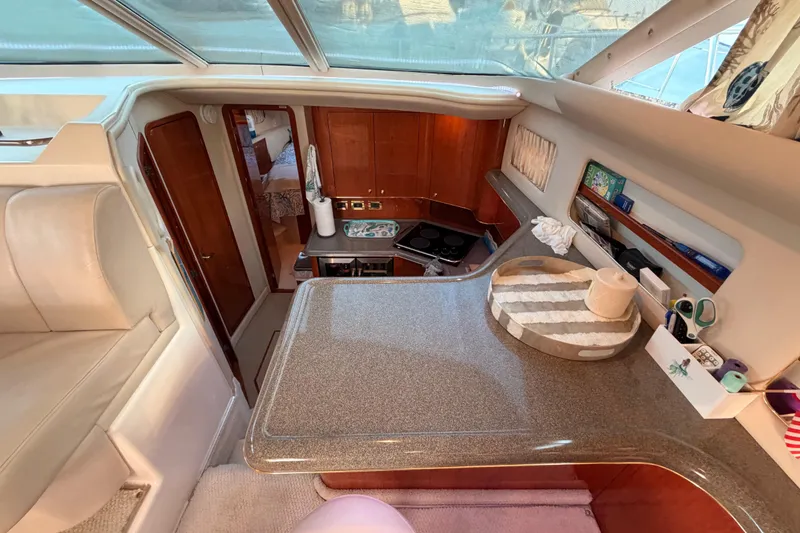 Slide: The Image of Interior of 1998 Sea Ray 420 Aft Cabin yacht with kitchen and seating area. - 49