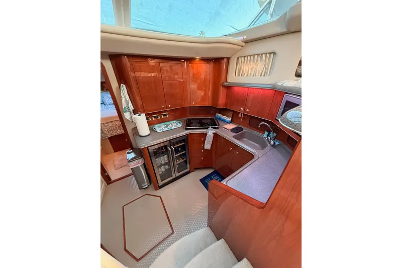 Slide: The Image of Luxurious 1998 Sea Ray 420 Aft Cabin yacht interior with modern kitchen amenities. - 50