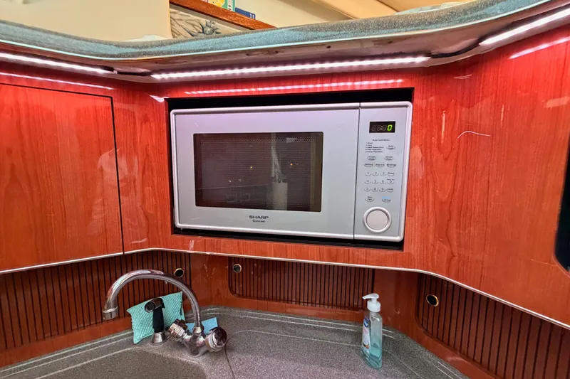 Slide: The Image of Microwave and sink in 1998 Sea Ray 420 Aft Cabin yacht kitchen. - 55
