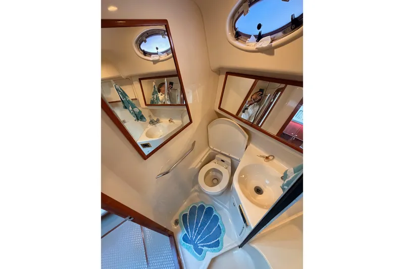 Slide: The Image of Bathroom interior of 1998 Sea Ray 420 Aft Cabin yacht with mirror and porthole. - 61