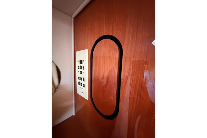 Slide: The Image of Control panel on 1998 Sea Ray 420 Aft Cabin's wooden interior wall. - 69